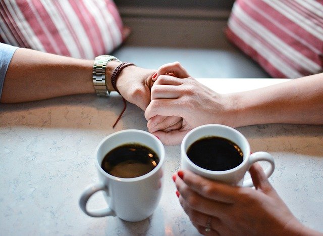 コーヒーカップと男女の手